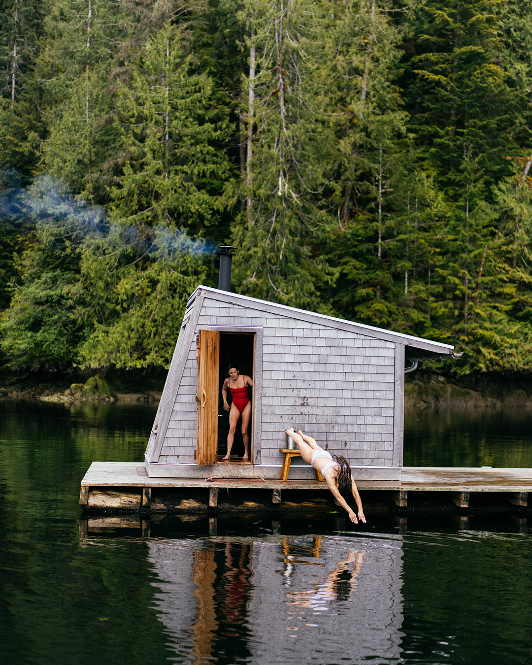 Two girls in Left On Friday Swimsuits jumping off dock