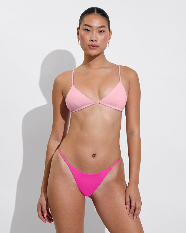 Woman in Sandy top in delight paired with skinny dip bottom in hot