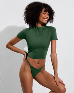 Woman in Rays Short Sleeve paired with Skinny Dip Bottom in Tropics