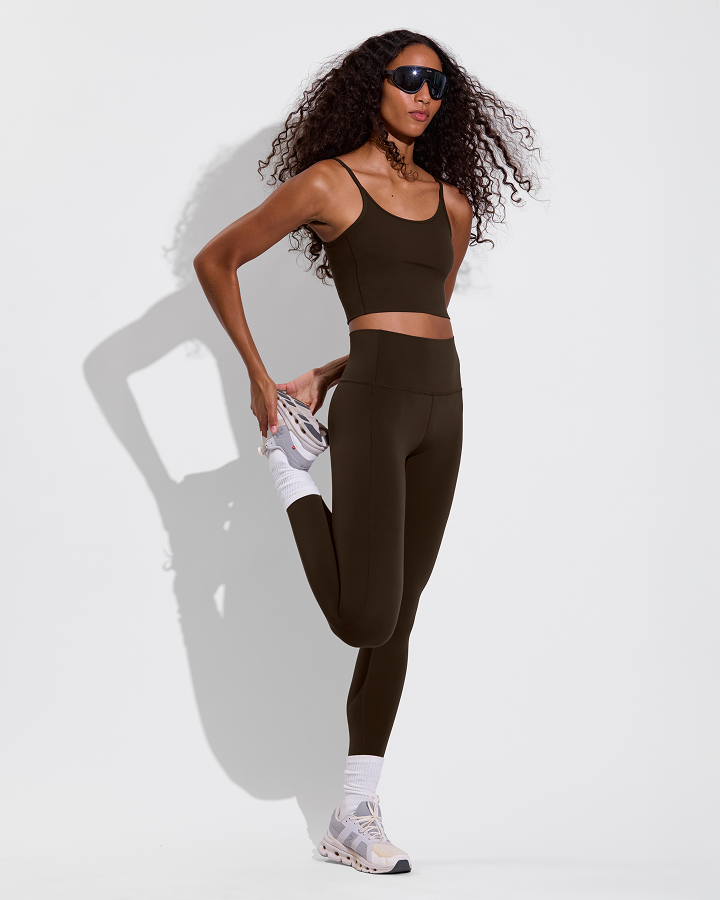 Woman in Barre tank and supermoves tight in cold brew