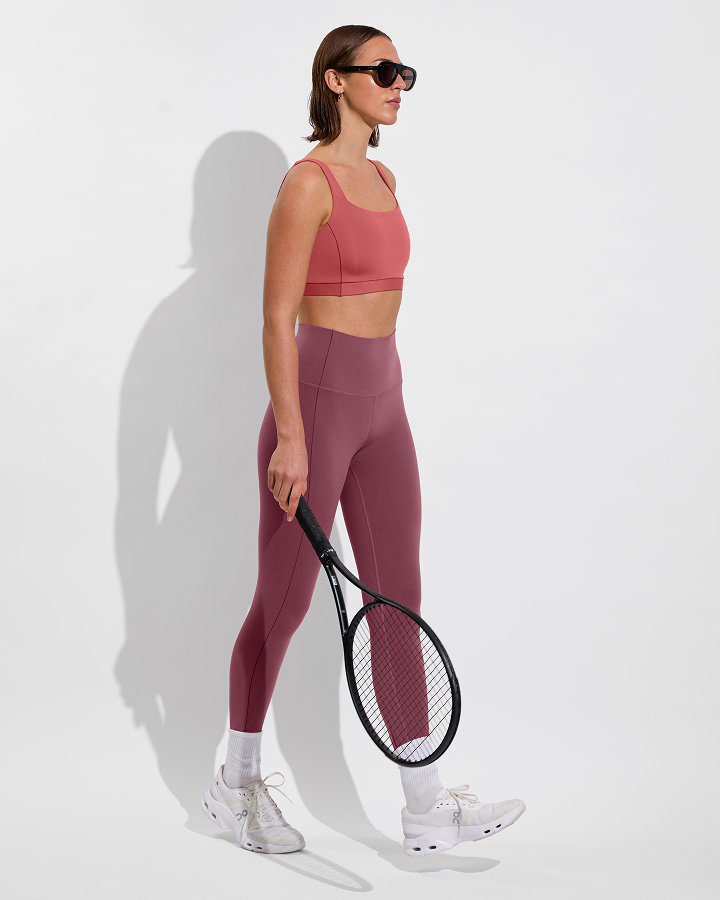 Woman in Double scoop top in camp paired with supermoves tight in desert plum