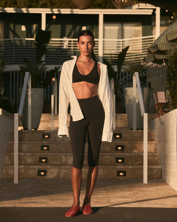 Woman in Plunge top + Pedal Pusher in Jet paired with Getaway Button down in coconut