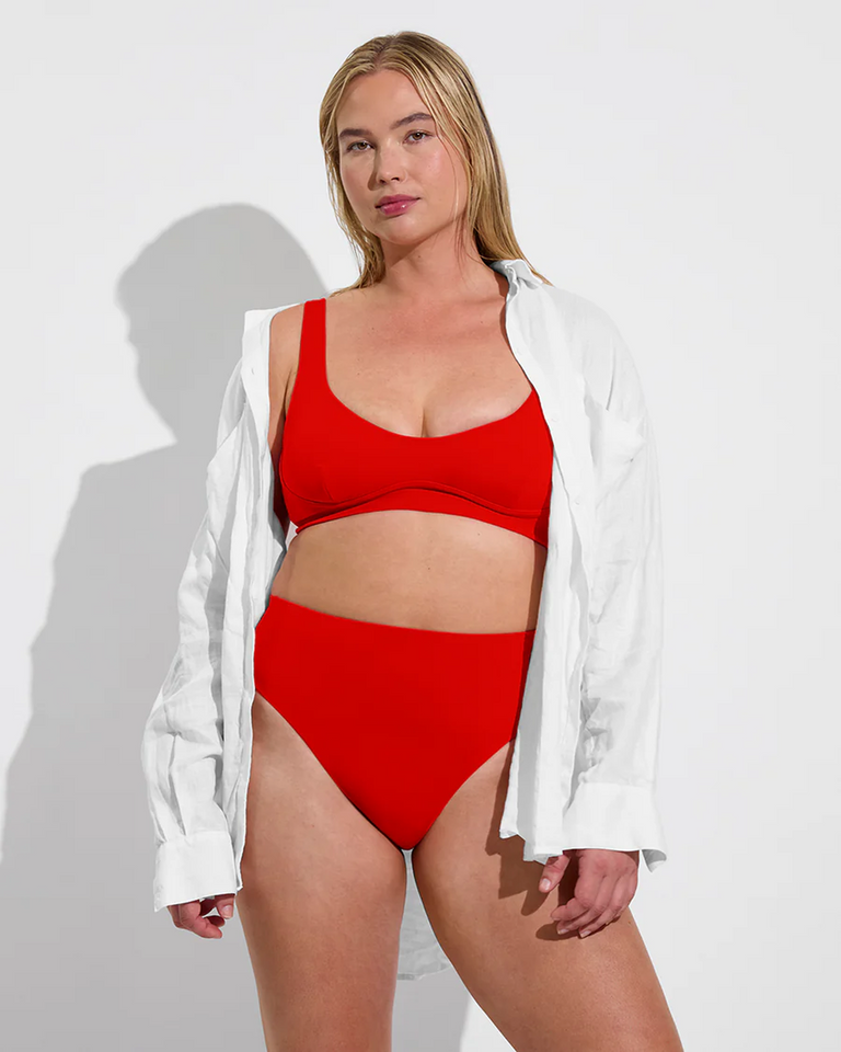 Woman in Club Top D and Hi Hi Bottom in Sweet Chili Heat paired with Getaway Button Down in Coconut 