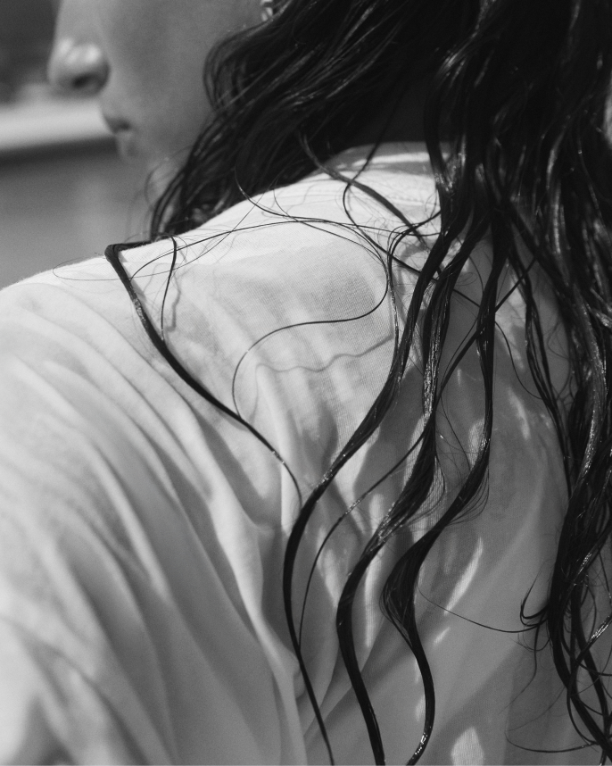 Close-up of a person wearing Swell Oversized Tee in Coconut