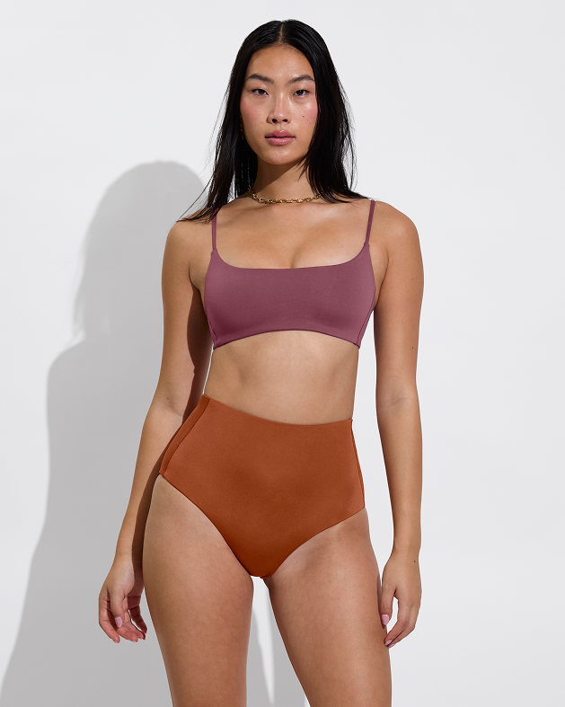 Woman in pool days top in desert plum paired with hi tide bottom in bronze