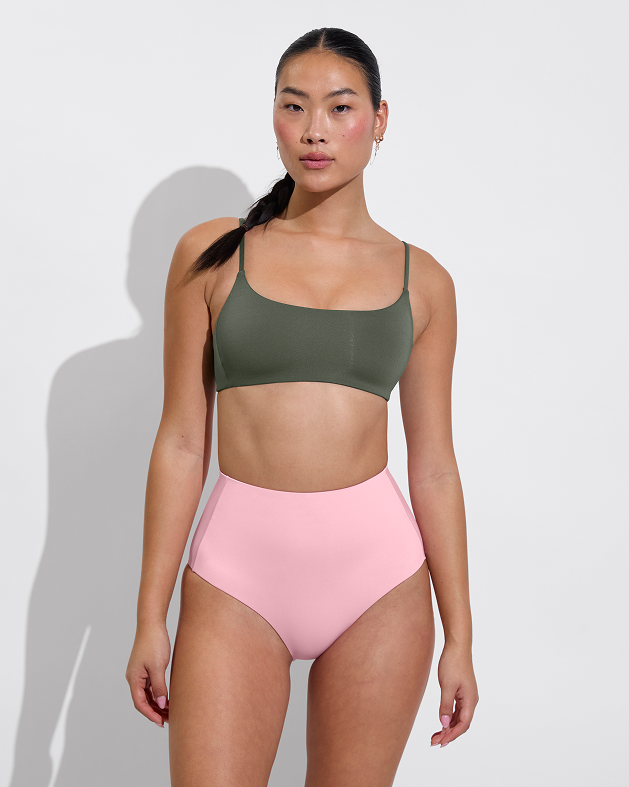 Woman in pool days top in agave paired with hi tide bottom in delight