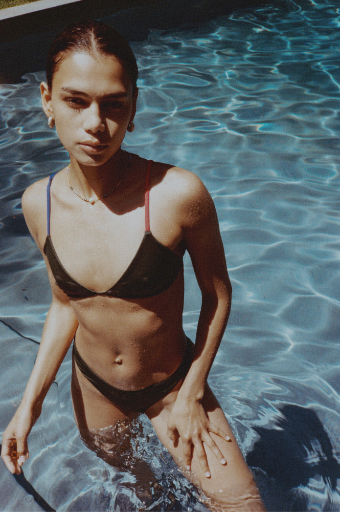 Woman wearing Sandy Top and Dip Bottom in Tropics standing in a pool