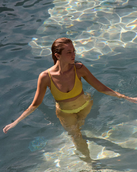 Woman in a pool wearing Sunday Top and Dip Bottom in Melt