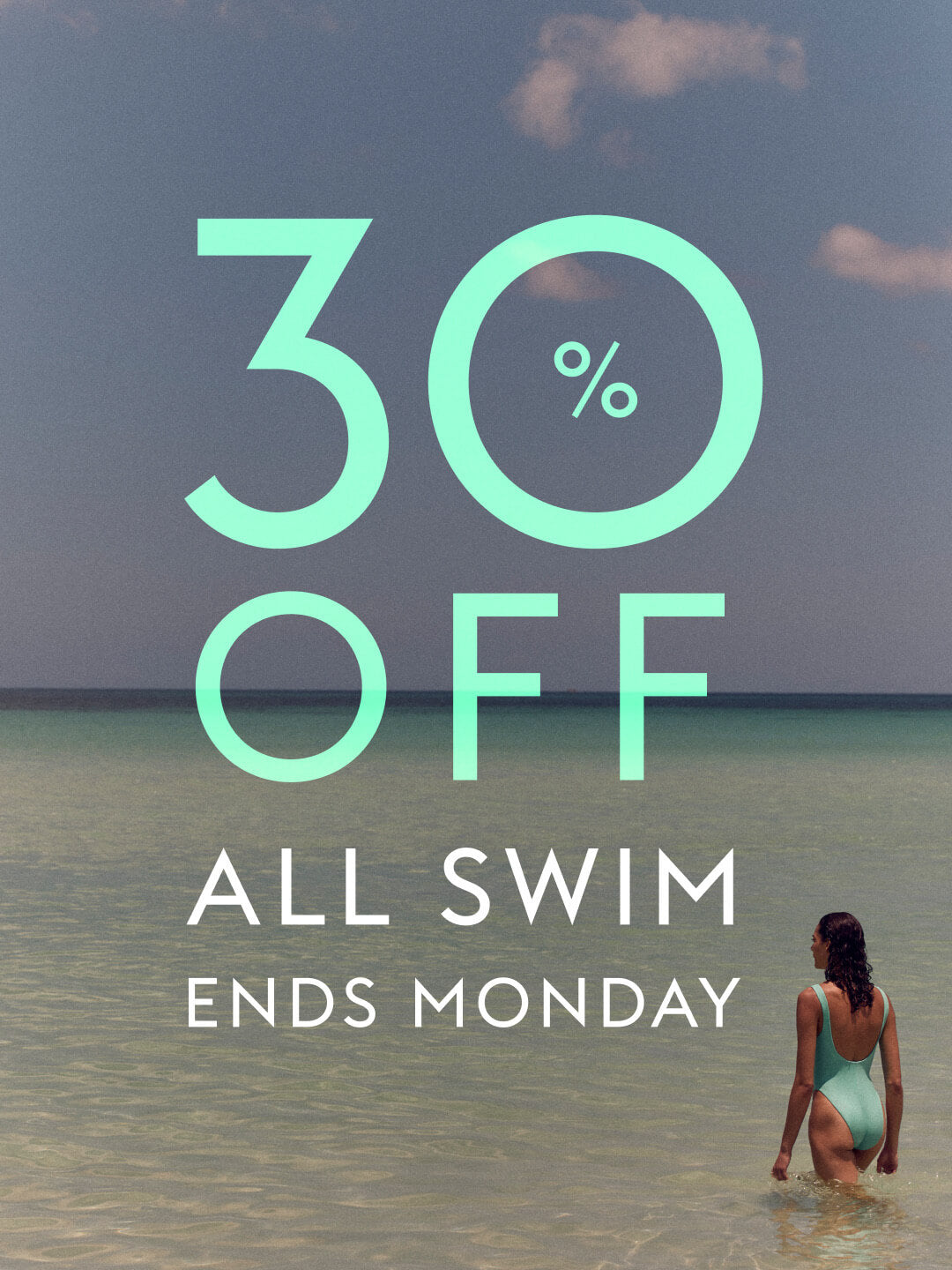 Promotional graphic with large mint-green text reading '30% OFF ALL SWIM ENDS MONDAY' over a beach scene, with a woman standing in shallow water at the lower right.