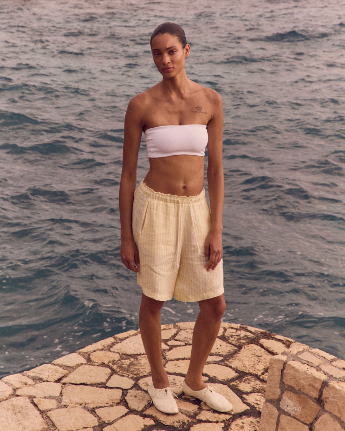 Woman in Tubular Top in Coconut paired with Getaway Short 9" in Melt / Coconut