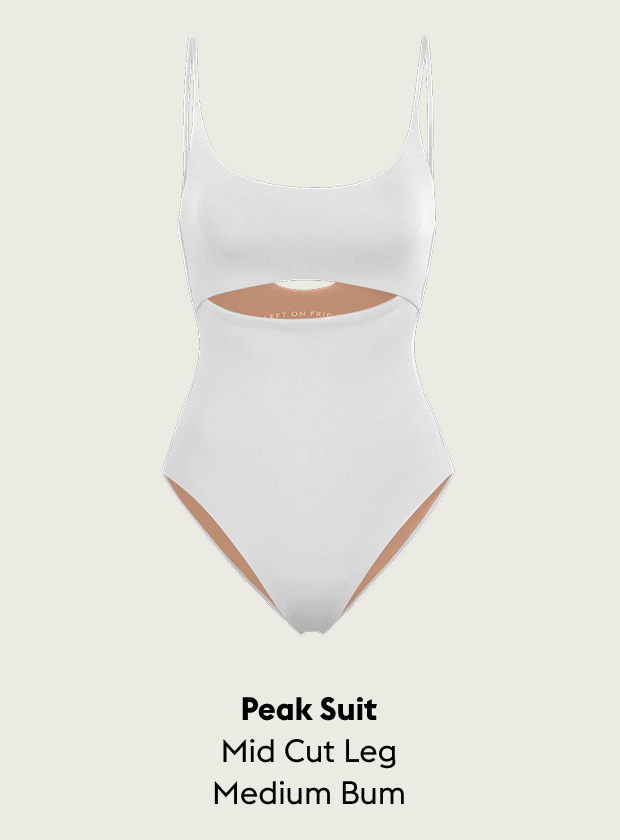 White Peak Suit with cut-out design on a light gray background