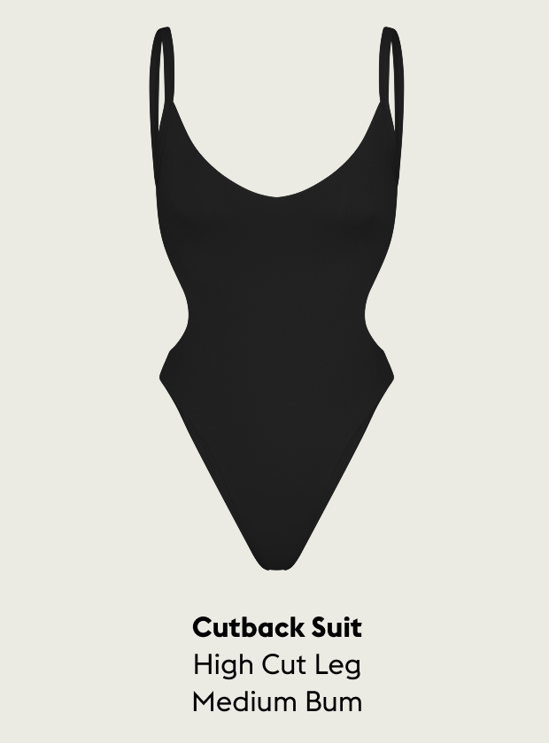 Black cutback swimsuit with thin straps on a light gray background