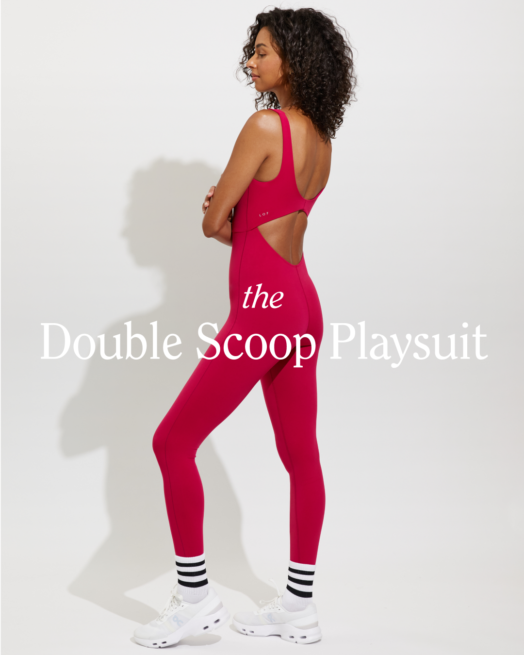 Woman wearing a Pepper 'Double Scoop Playsuit' with text overlay on a white background